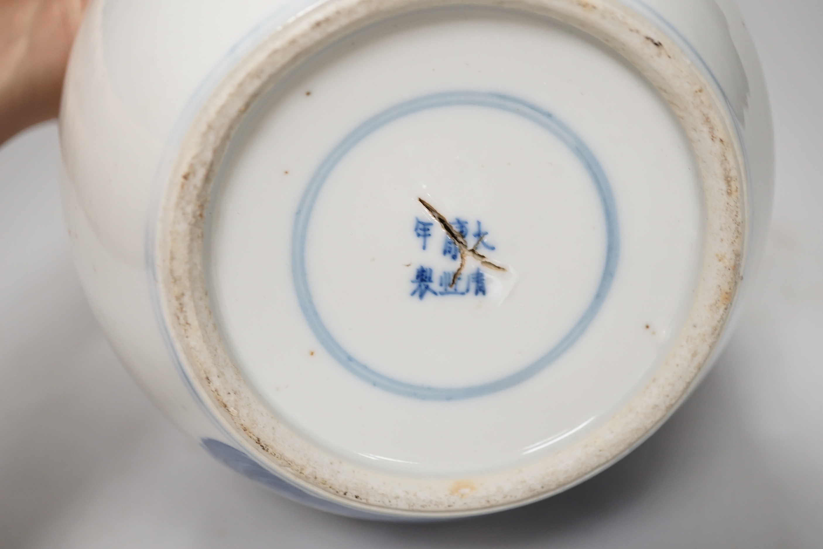 A 19th century Chinese blue and white jar and cover, hand painted with figures in a landscape, 20cm high